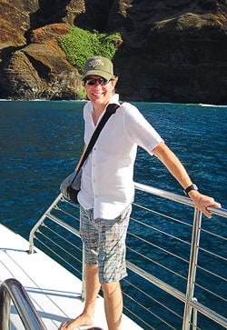 The world's largest hibiscus is on the cliff behind Carl. Photo by Bev Amoth