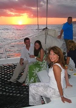 Bev and new friends enjoying the sea and sunset aboard a 65' catamaran, the Tropicat