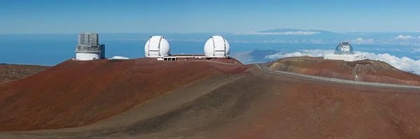 Some of the observatories on the summit of Mauna Kea. Mt Haleakala, in Maui, is visible on the horizon (some 80 miles away). © Carl Amoth