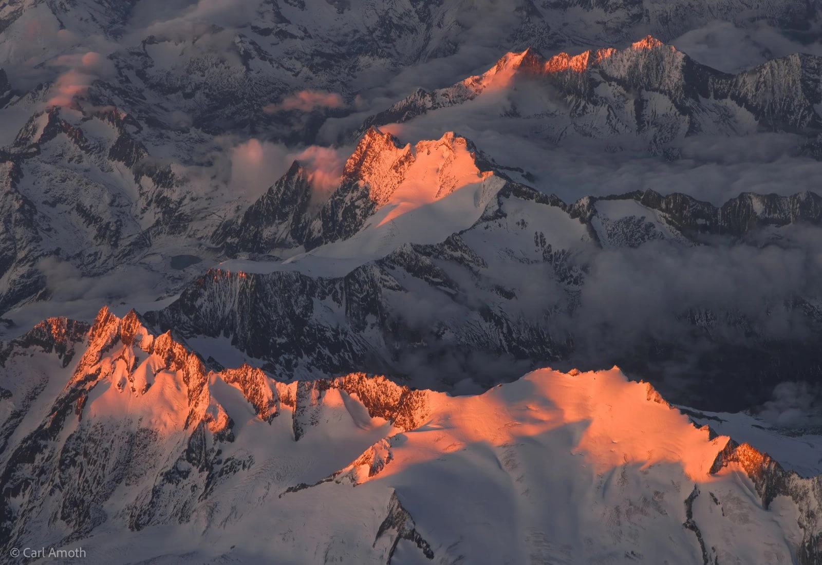 The breathtaking beauty of the Swiss Alps at sunset (on our descent into Bologna, from London).