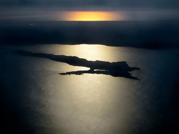 Parting Shot: Sun setting over the Sea of Cortez (foreground), Baja peninsula, and the Pacific (background) at 30,000 ft.