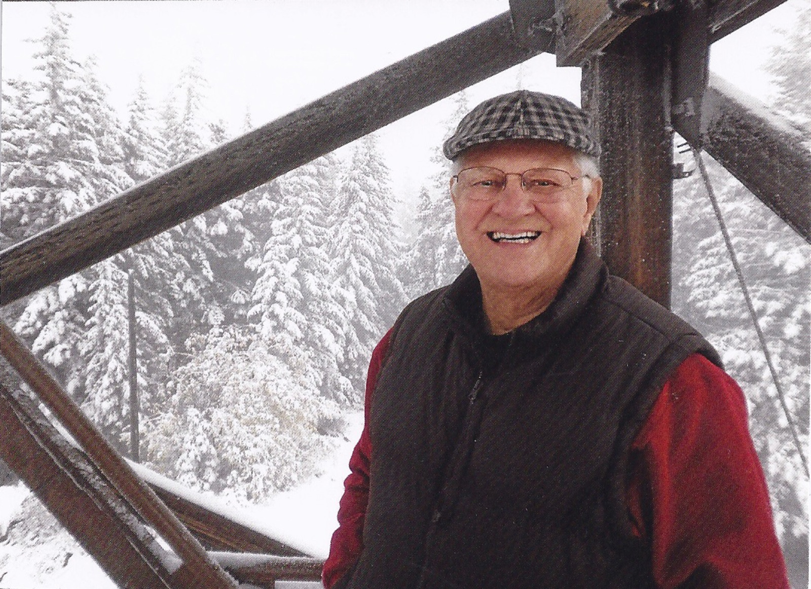 Pete Amoth in later life, smiling, in a red jacket and cap