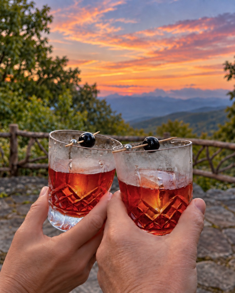 Two glasses of The Hunter over ice, each with a cherry on a pick