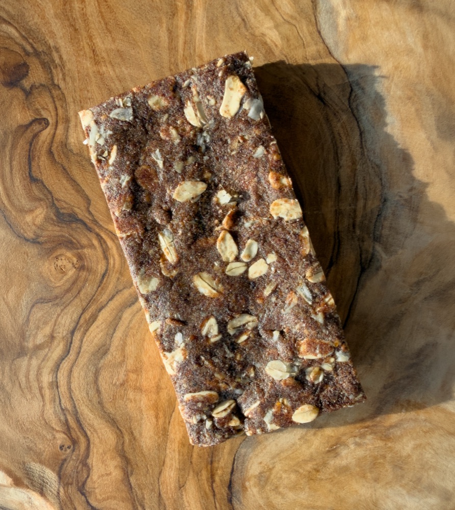 A nut butter and jam bar on a wooden surface